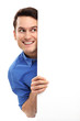 Man peeping over blank poster