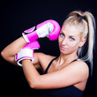 beautiful, fit woman wearing hot pink boxing gloves