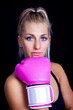 beautiful, fit woman wearing hot pink boxing gloves