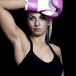 beautiful, fit woman wearing hot pink boxing gloves