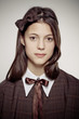 teen school girl wearing old style formal clothes - sepia
