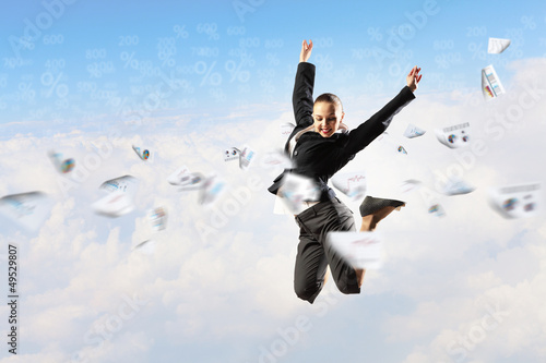 Photo: businesswoman in black suit jumping businesswoman in black suit jumping