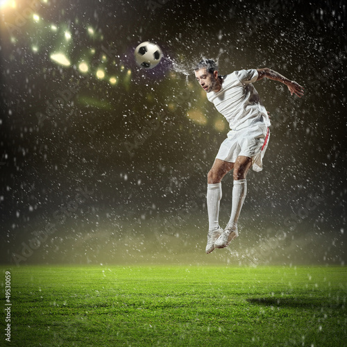 Photo: football player striking the ball football player striking the ball