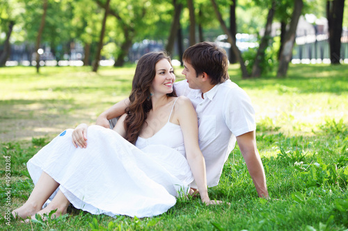 Photo: Young love Couple smiling under blue sky Young love Couple smiling under blue sky