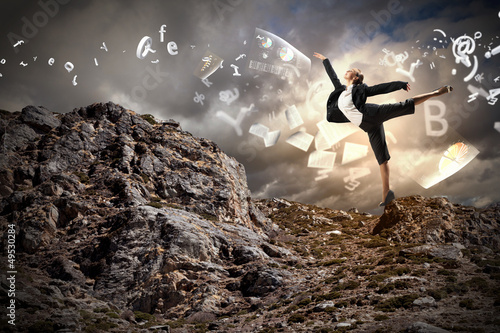 Photo: businesswoman standing atop of mountain businesswoman standing atop of mountain