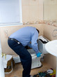 Plumber fixing toilet