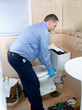 Plumber fixing toilet