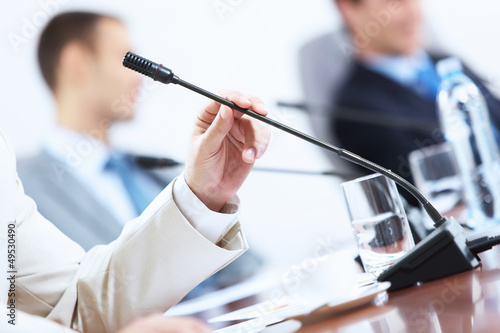 Photo: Hands of businessman holding microphone Hands of businessman holding microphone