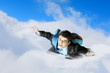 Young businessman flying with parachute on back