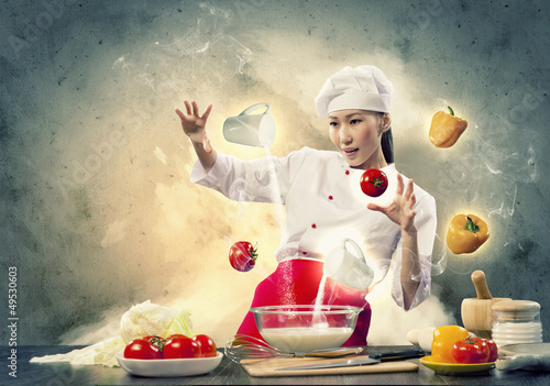 Photo: Asian female cooking with magic Asian female cooking with magic
