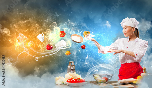 Photo: Asian female cooking with magic Asian female cooking with magic