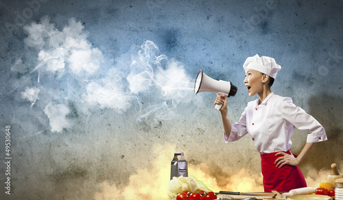 Photo: Asian female cook holding megaphone Asian female cook holding megaphone