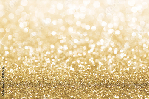 Photo: Gold defocused glitter background with copy space Gold defocused glitter background with copy space