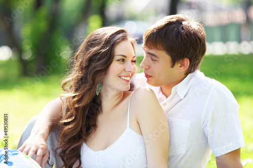 Photo: Young love Couple smiling under blue sky Young love Couple smiling under blue sky