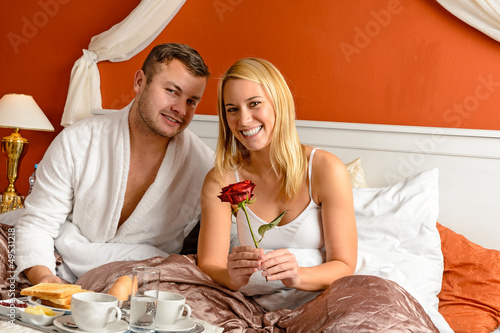 Photo: Smiling couple bed breakfast celebrating Valentine's Smiling couple bed breakfast celebrating Valentine's