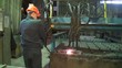 man in a helmet at the factory working with the machine