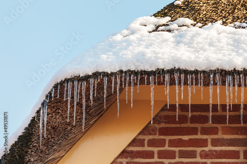 Photo: Icicles hanging on the roof of an old Dutch farm Icicles hanging on the roof of an old Dutch farm