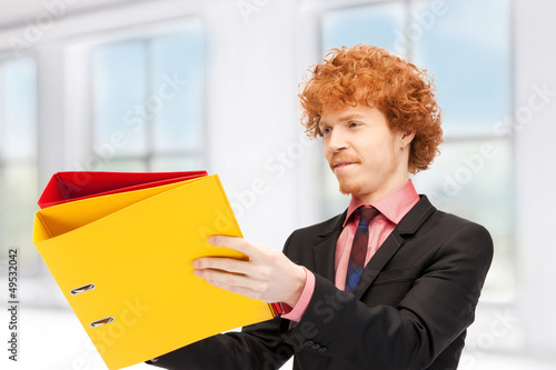 Photo: man with folders man with folders