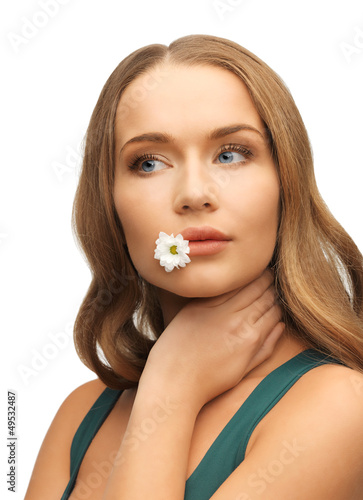 Photo: woman with camomile in mouth woman with camomile in mouth