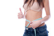 Photo: Young woman measuring her waist Young woman measuring her waist