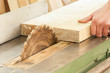 Carpenter working on woodworking machines in carpentry shop.