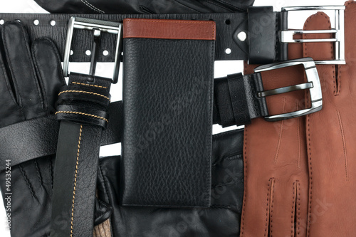 Photo: Men's wallet lying on the belts and gloves Men's wallet lying on the belts and gloves