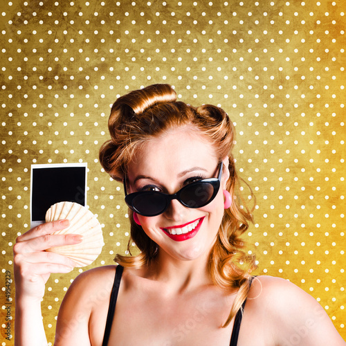 Photo: Happy Young Pin-Up Woman Showing Travel Picture Happy Young Pin-Up Woman Showing Travel Picture