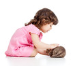 little kid girl playing with cat kitten