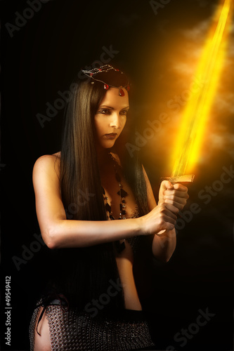 Photo: sexy woman warrior with fire sword sexy woman warrior with fire sword