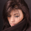Artistic portrait of brunette on a dark background