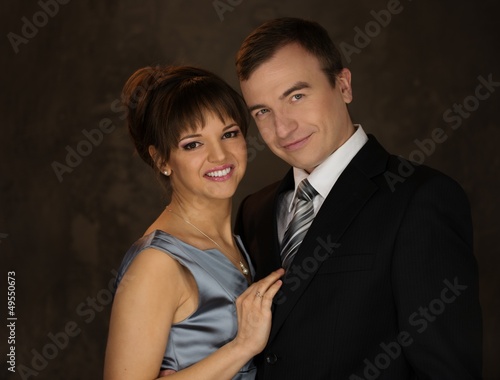 Photo: Happy elegant couple in classic dress Happy elegant couple in classic dress