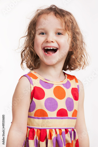 Photo: Happy little girl in a bright dress Happy little girl in a bright dress