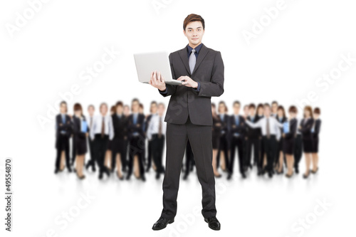 Photo: smart businessman holding laptop and successful business team smart businessman holding laptop and successful business team