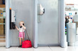 Foto: child talking the phone in the airport child talking the phone in the airport