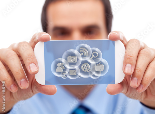 Photo: Businessman with smart gadget accessing cloud applications Businessman with smart gadget accessing cloud applications