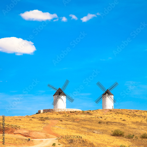 Photo: Windmills, rural green fields and blue sky. Consuegra, Spain Windmills, rural green fields and blue sky. Consuegra, Spain