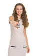 Happy young woman switching channels with tv remote control