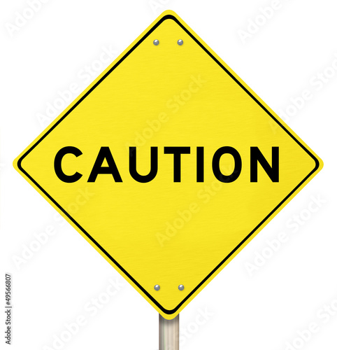 Photo: Caution - Yellow Warning Sign - Isolated Caution - Yellow Warning Sign - Isolated