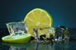 Ice cubes with lime on darck blue background