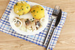 Dish of herring and potatoes on plate on wooden table close-up