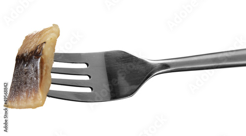 Photo: Piece of herring on fork isolated on white Piece of herring on fork isolated on white