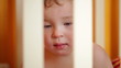 Video: Little boy watching a film in the playpen. Little boy watching a film in the playpen.