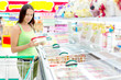 Woman buying ice-cream at the supermarket