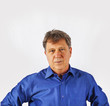 Portrait of a confident senior man standing on white background