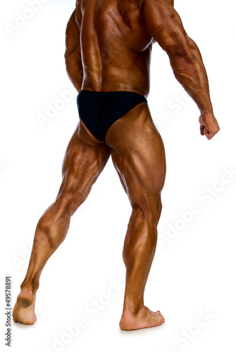 Photo: Legs muscular man back view on white background Legs muscular man back view on white background