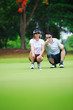 Photo: Professional teaching young woman golfer Professional teaching young woman golfer