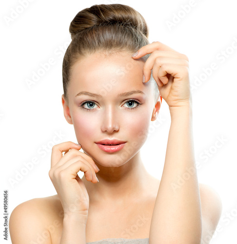 Photo: Beautiful Young Woman with Fresh Clean Skin touching her Face Beautiful Young Woman with Fresh Clean Skin touching her Face