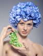 beautiful young girl with green grapes