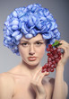 beautiful young girl with red grapes