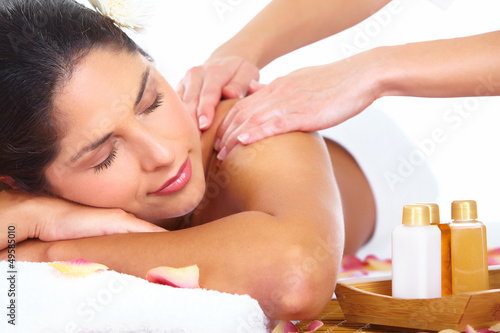 Photo: Young woman getting massage in spa salon. Young woman getting massage in spa salon.